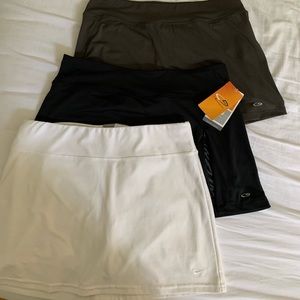 3 medium tennis skirts (1 Nike, 2 champion) in white, grey and black
